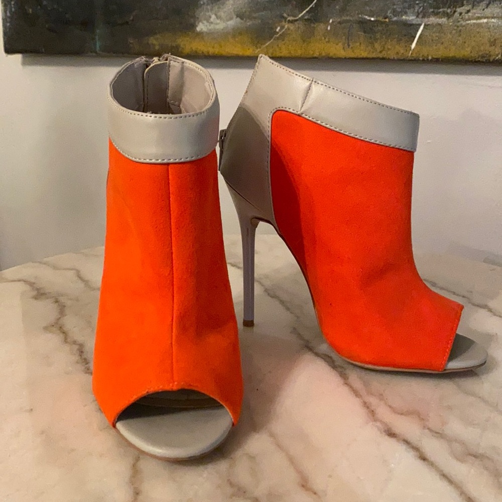 Orange faux suedes open toe heeled booties.
